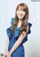 A woman in a blue dress posing for a magazine.